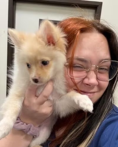 La Verne vet team member Jordan holding a small puppy at Pet Depot Veterinary Group 